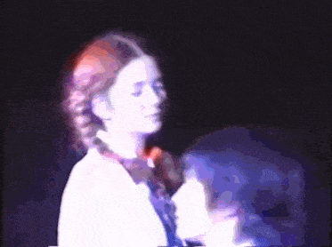 a blurry picture of two people standing next to each other in a dark room