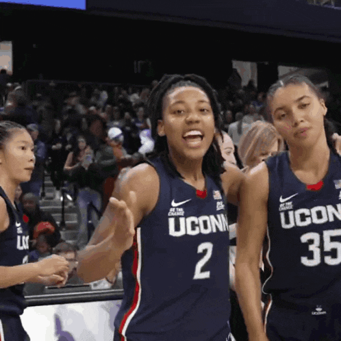 a group of uconn basketball players stand together