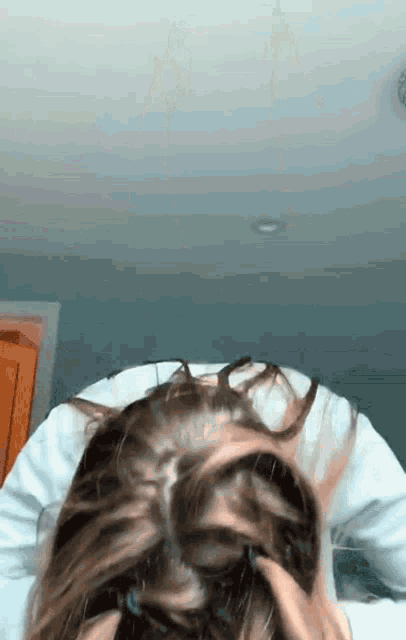 a close up of a person 's head with their hair in a bun