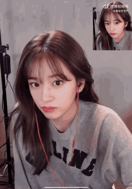 a girl wearing headphones and a celine sweater