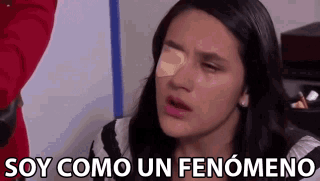 a woman with a bandage on her eye is crying and saying soy como un fenomeno .