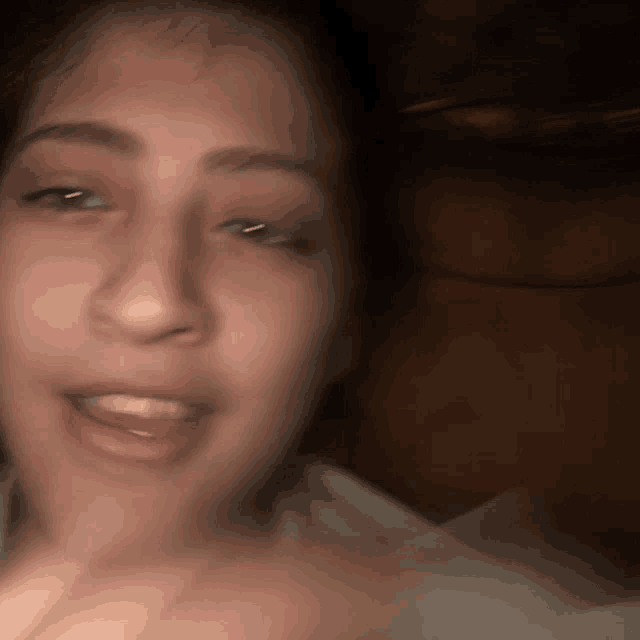 a blurry picture of a woman 's face with her tongue out