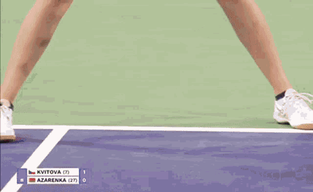 a woman in a red and blue skirt is holding a tennis racquet while playing tennis