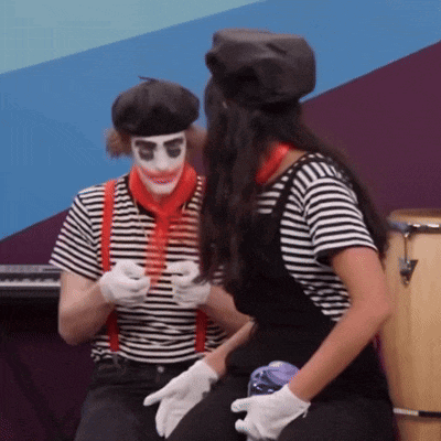 a man and a woman dressed as mimes are dancing together