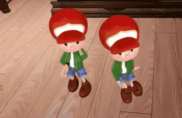 two cartoon characters wearing red hats are standing on a wooden floor