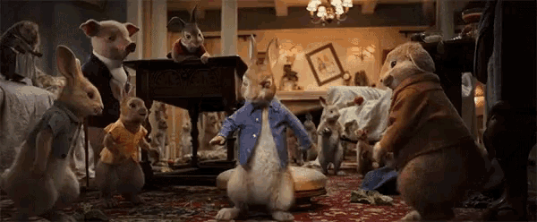 a group of stuffed animals are gathered around a rabbit in a living room .