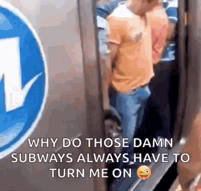 a man is standing in front of a sign that says why do those damn subways always have to turn me on .