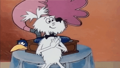 a cartoon character is sitting on a table next to a phonograph .