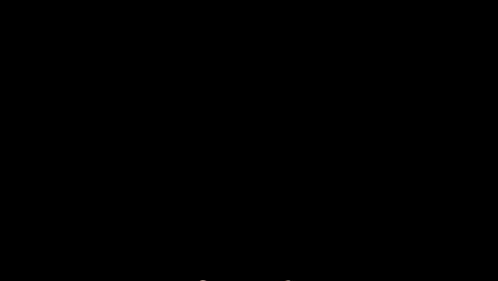 a close up of a cat 's face with red eyes and a black background