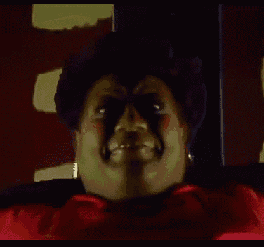 a close up of a woman 's face with a red shirt