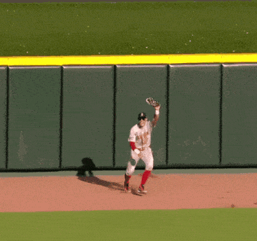 a baseball player in a boston uniform is running on the field