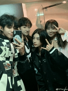 a group of young people are taking a selfie together in a bathroom .