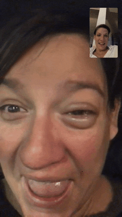 a close up of a woman 's face with a man 's face behind her