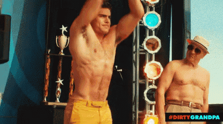 a shirtless man stands next to an older shirtless man with the hashtag #dirtygrandpa