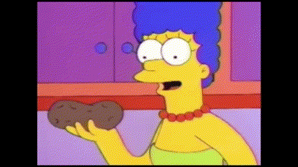 marge simpson from the simpsons is holding a potato in her hand .