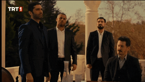 a group of men standing next to each other with trt1 written on the screen