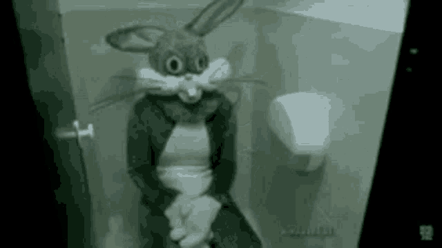 a person wearing a bunny costume is sitting on a toilet .