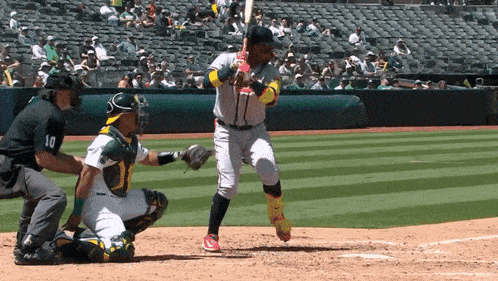 a baseball player with the number 10 on his jersey is swinging at a pitch
