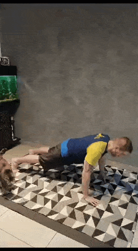 a man is doing push ups on a rug in a living room while a woman watches .