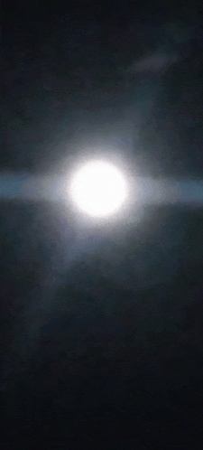 a full moon is shining brightly in the dark night sky