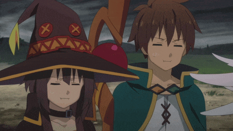 a boy and a girl are standing next to each other and the girl is wearing a witch hat with an x on it