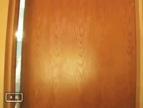 a woman with a towel wrapped around her head is standing in front of a door