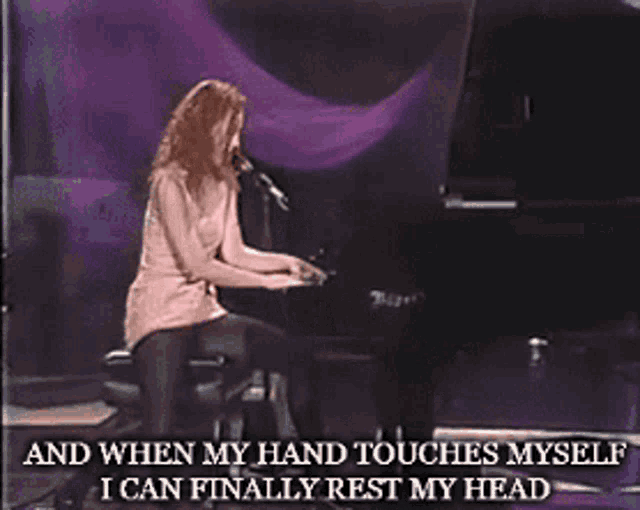 a woman sings into a microphone while playing a piano