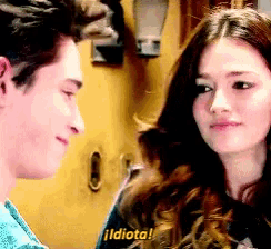 a man and a woman are looking at each other and the woman is saying idiota