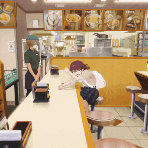 a girl is sitting at a counter in a restaurant with a sign that says no smoking