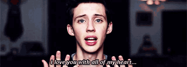a young man is saying that he loves you with all of his heart