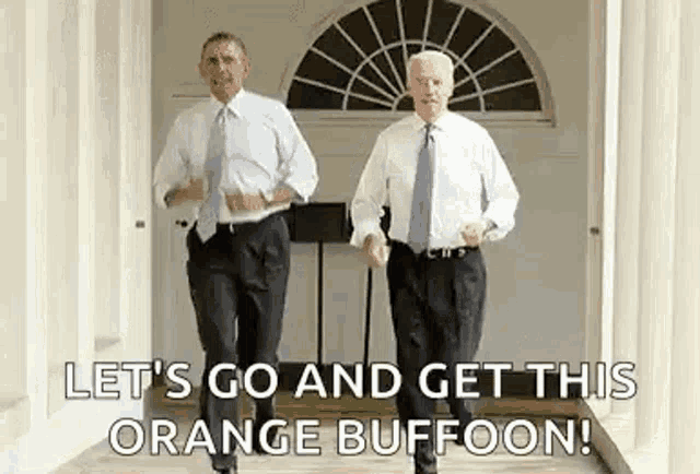 two men in suits and ties are walking down a hallway and dancing .