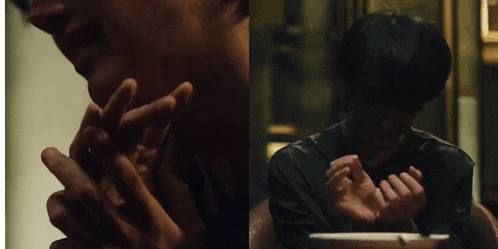 a close up of a person 's hands with a plate in the background