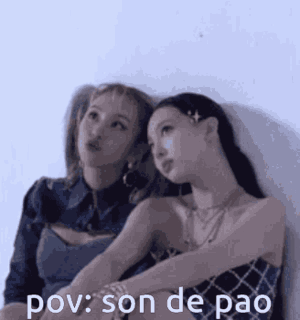 a couple of women sitting next to each other with the words pov son de pao written on the bottom .