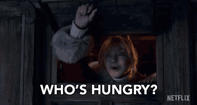 a woman is looking out of a window and asking who 's hungry