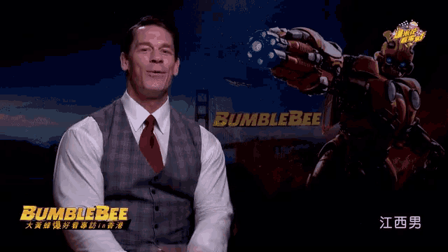 a man in a suit and tie stands in front of a bumblebee sign