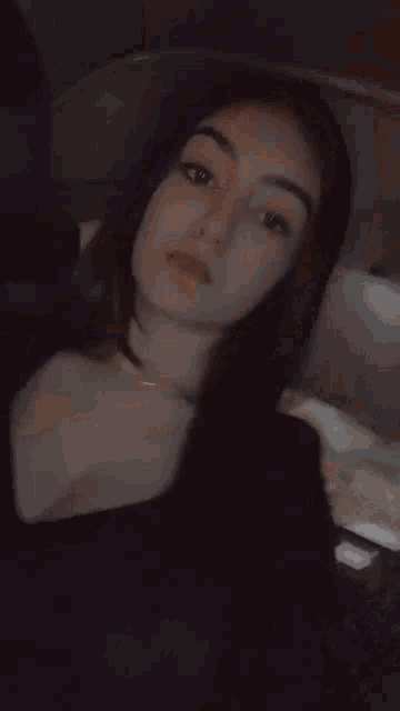 a close up of a woman 's face with a black shirt on .