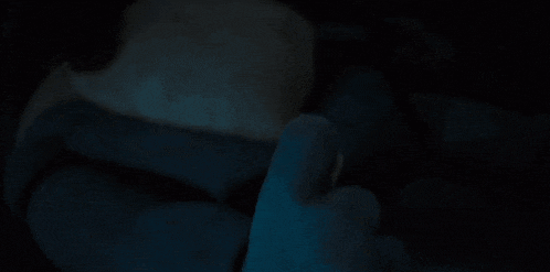 a person 's hand is glowing in the dark