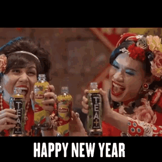 two women toasting with lipton tea bottles