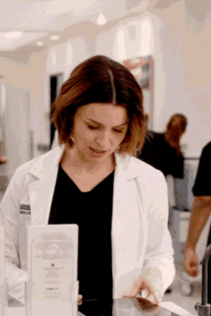 a woman in a lab coat has a name tag on her chest that says ' smith '