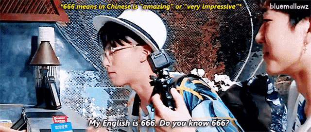a man in a white hat is talking to another man who is holding a camera