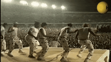 a group of people are dancing in front of a crowd