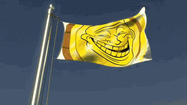 a yellow flag with a troll face on it is waving in the wind
