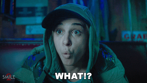 a woman wearing a hooded jacket says " what "