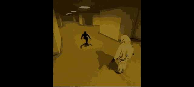 a person in a white hoodie is standing in a hallway