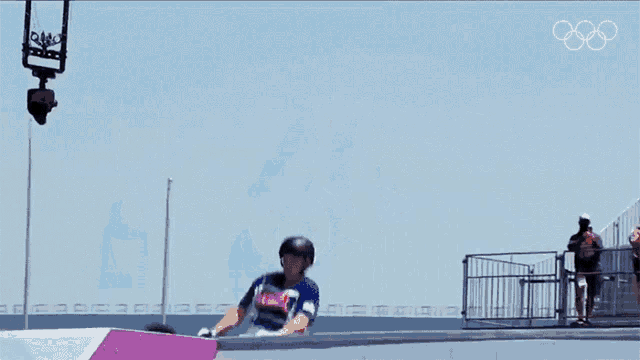 a man is doing a trick on a bmx bike in front of a sign that says women 's park final