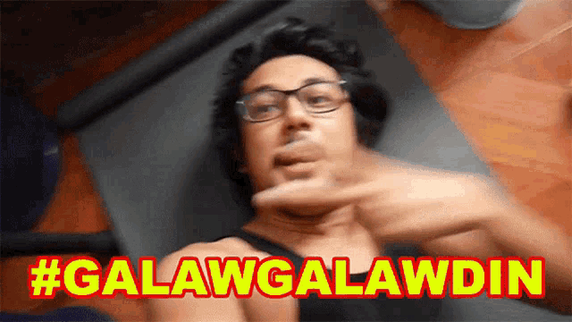 a man wearing glasses is laying on a yoga mat with the hashtag #galawgalawdin written above him
