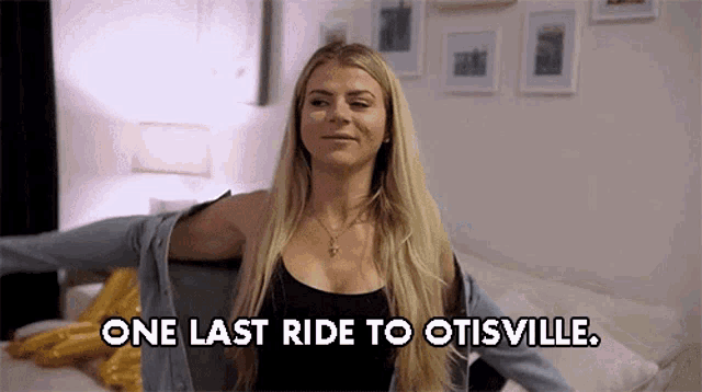 a woman is sitting on a bed with her arms outstretched and the words one last ride to otisville above her