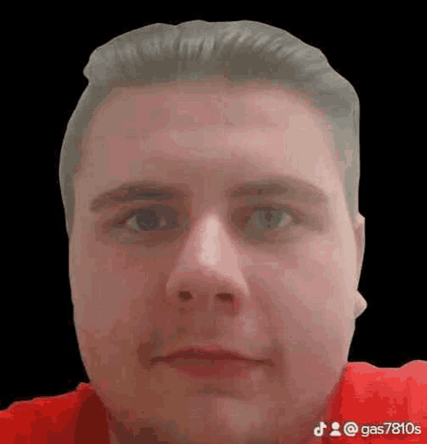 a man in a red shirt is making a funny face .