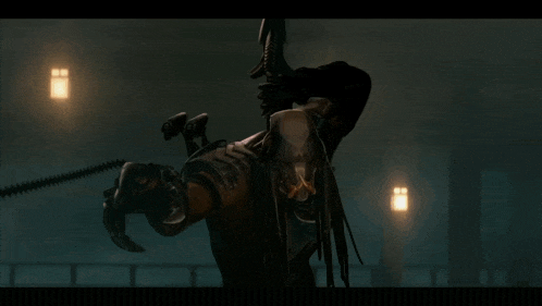 a predator is holding a large spear in his hand