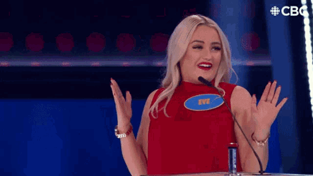 a woman in a red top with a name tag that says ty on it